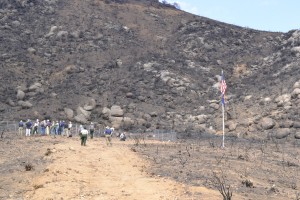 The media gathers around a fenced area where the Granite Mountain Hotshots deployed their shelters on June 30, 2013.