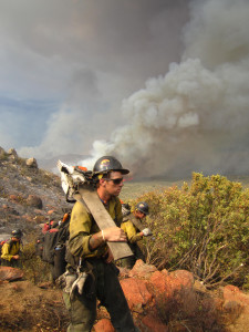 Two Granite Mountain hotshots with saws on their shoulders shortly before 4 p.m., June 30, 2013 at the Yarnell Hill Fire. Photo by Christopher MacKenzie.