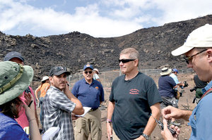 Former Prescott Wildland Division Chief Darrell Willis, foreground right, answers media questions at the deployment site where the Granite Mountain Hotshots died. Photo by John Dougherty