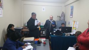 Peru National Police officer Edgar Abarca Lezama holding documents during detention proceedings Cucso, Peru against John Dougherty and Jen Moore.